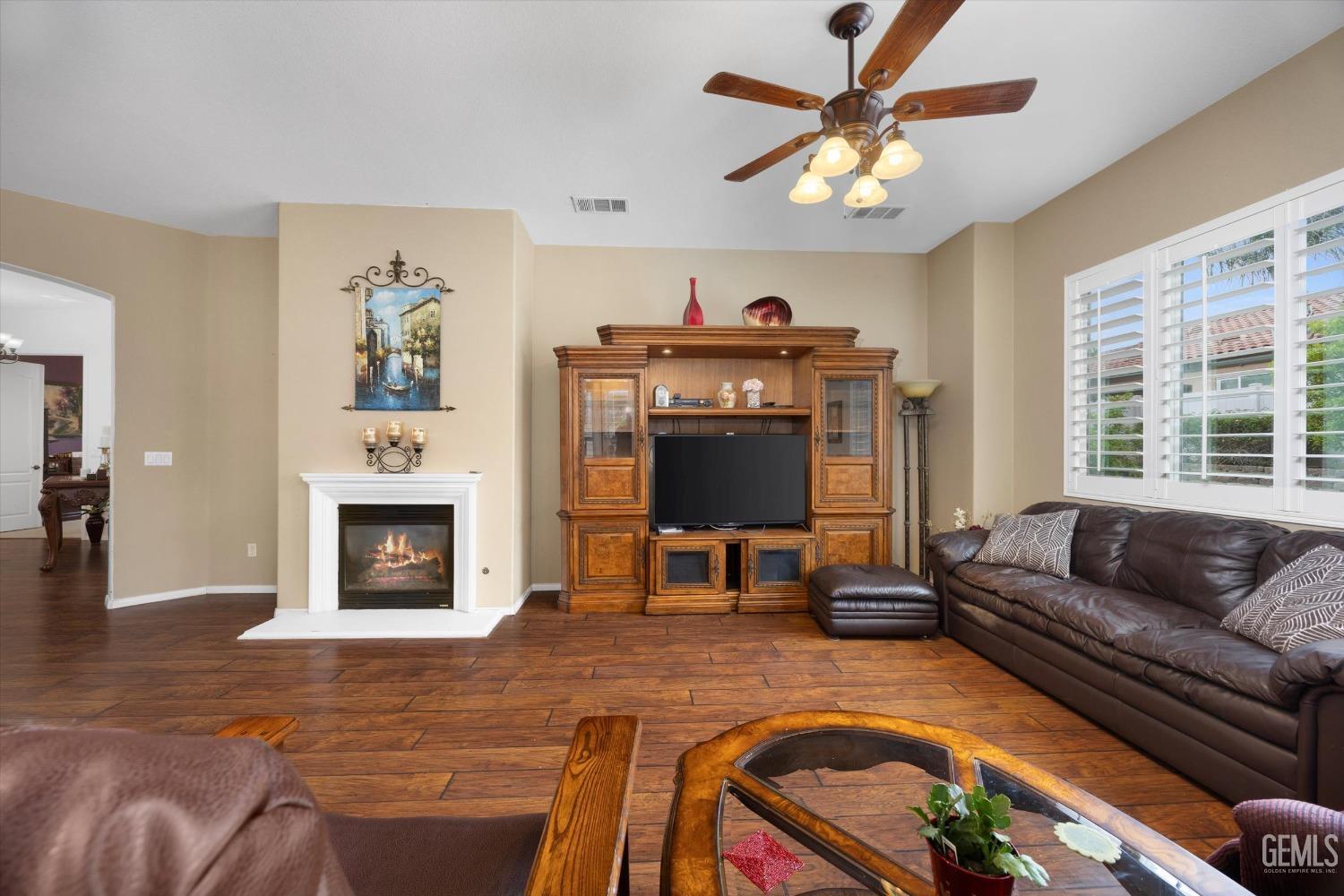 Undisclosed Address Bakersfield, CA 93306 - Photo 18 of 48 a living room with furniture and a fireplace