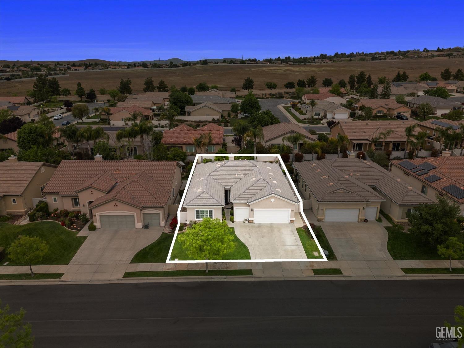 Undisclosed Address Bakersfield, CA 93306 - Photo 47 of 48 an aerial view of multiple houses with a yard