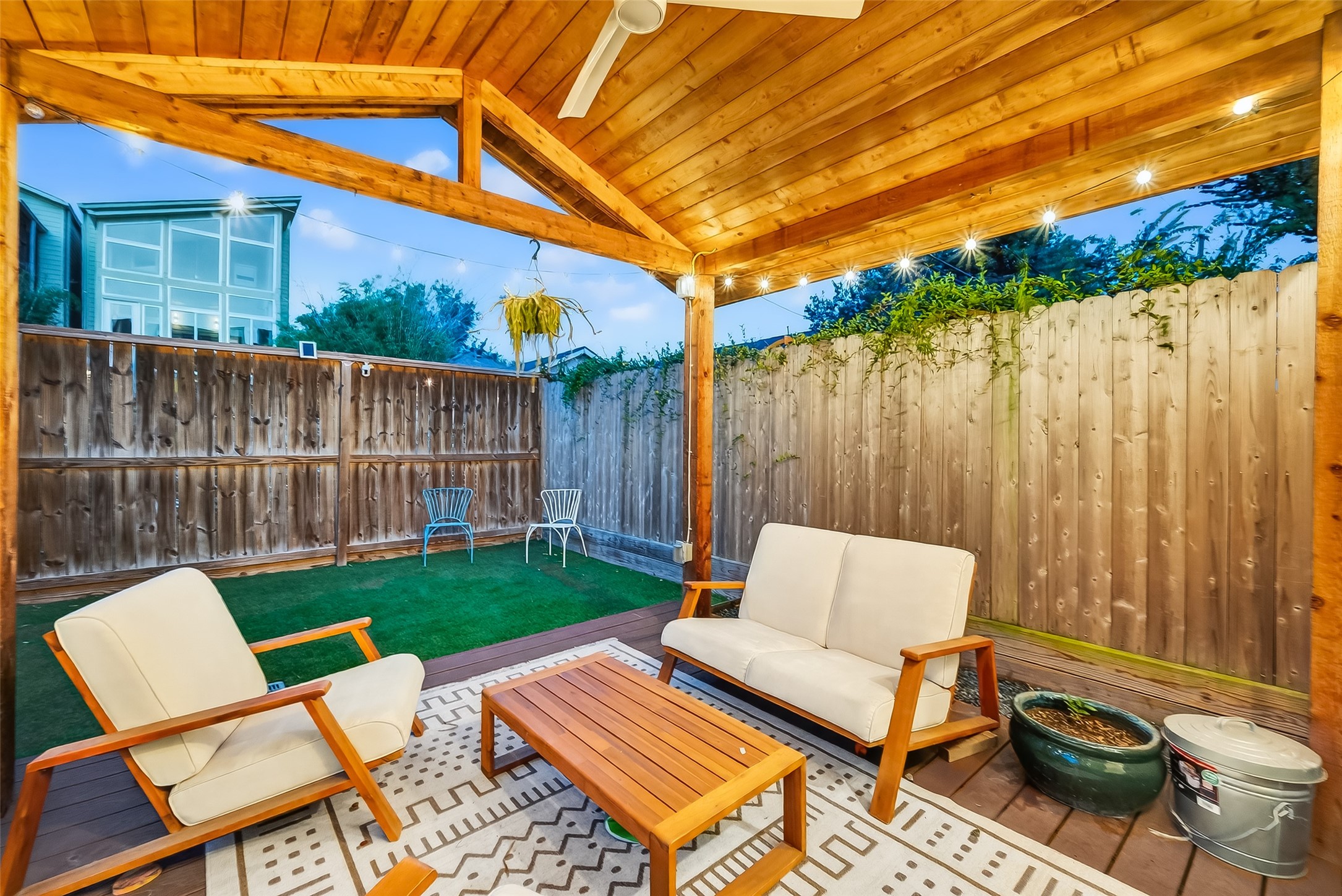 515 West 25th Street Houston, TX 77008 - Photo 26 of 35 Backyard includes a 12’1” x 11’6” covered pergola with warm wood accents, creating a comfortable outdoor living area overlooking the artificial-turf yard and full privacy fence.