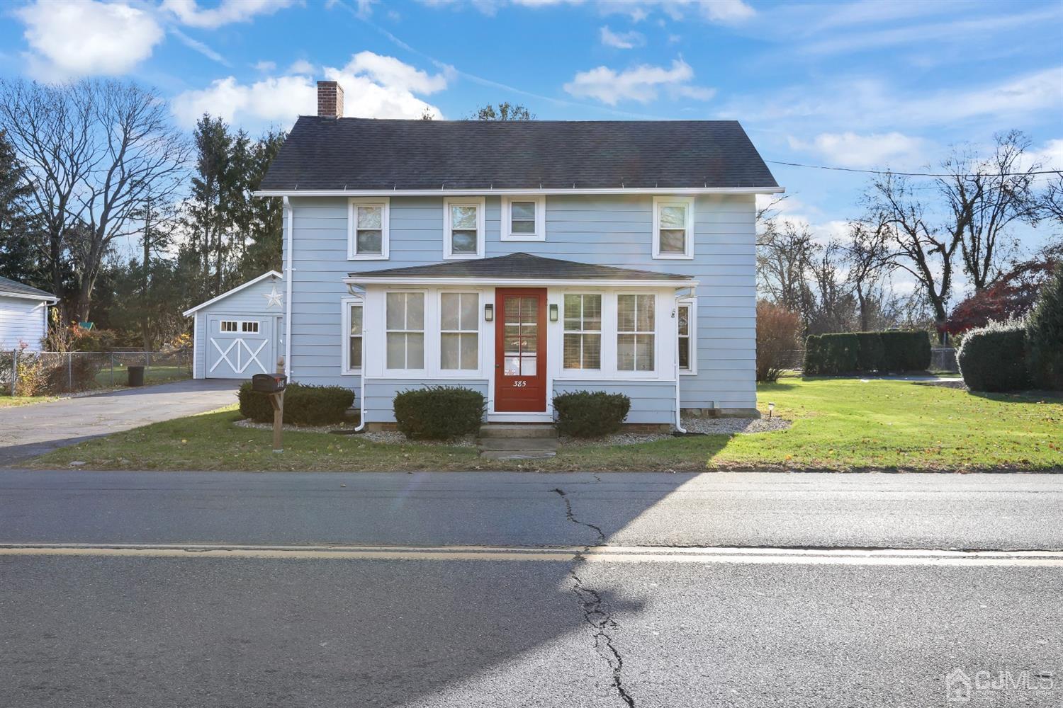 385 Ridge Road Dayton, NJ 08810 - Photo 2 of 29 a front view of a house with a yard and trees