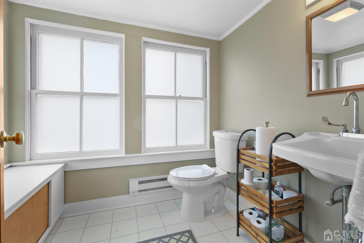 385 Ridge Road Dayton, NJ 08810 - Photo 15 of 29 a bathroom with a sink a toilet and a window