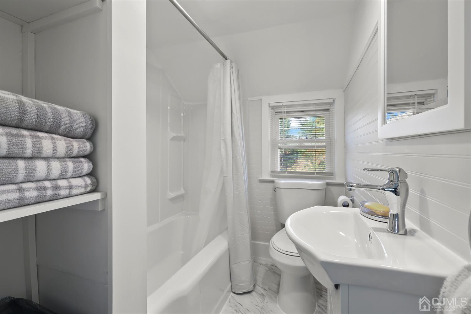 385 Ridge Road Dayton, NJ 08810 - Photo 19 of 29 a bathroom with a sink a toilet and shower