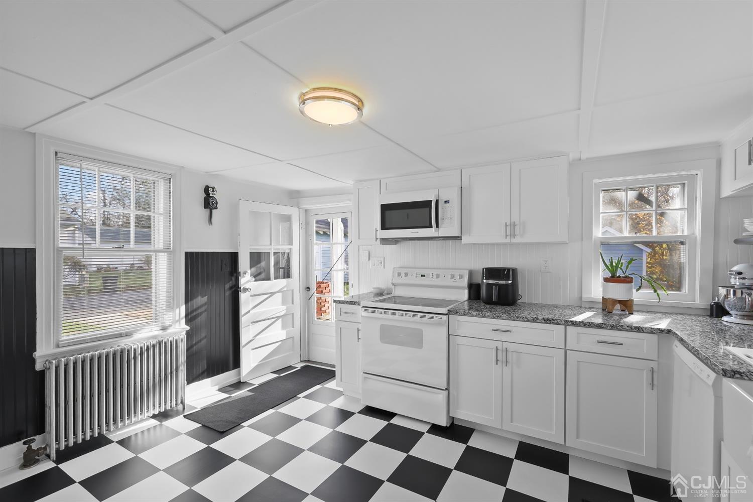385 Ridge Road Dayton, NJ 08810 - Photo 7 of 29 a kitchen with stainless steel appliances a sink stove refrigerator and cabinets