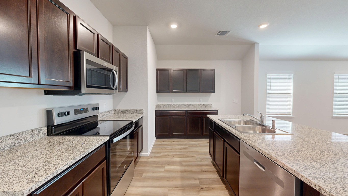 6801 Gilbert Drive Killeen, TX 76549 - Photo 2 of 27 a kitchen with granite countertop stainless steel appliances and sink
