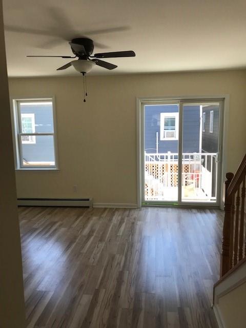 19 Stanton Road Brooklyn, NY 11235 - Photo 3 of 12 a view of an empty room with a window and wooden floor
