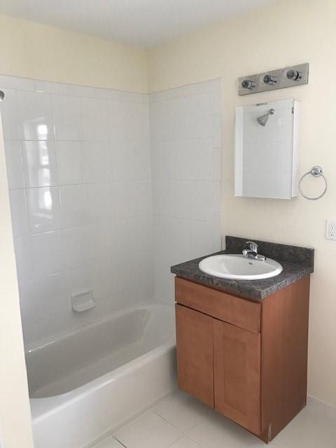 19 Stanton Road Brooklyn, NY 11235 - Photo 9 of 12 a bathroom with a sink a vanity and mirror