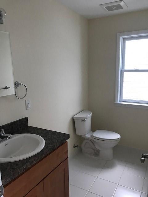 19 Stanton Road Brooklyn, NY 11235 - Photo 10 of 12 a bathroom with a granite countertop toilet and sink