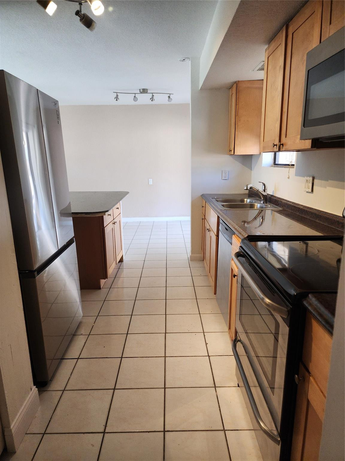 704 Southwest 4th Street Hallandale Beach, FL 33009 - Photo 17 of 33 a kitchen with a sink a stove cabinetry and refrigerator