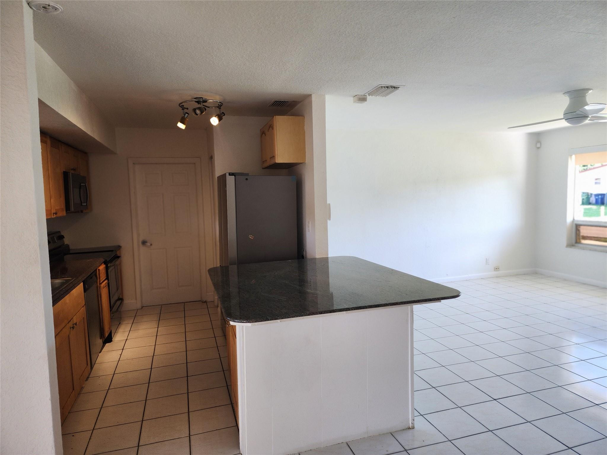 704 Southwest 4th Street Hallandale Beach, FL 33009 - Photo 23 of 33 a kitchen with stainless steel appliances granite countertop a refrigerator a stove and a refrigerator