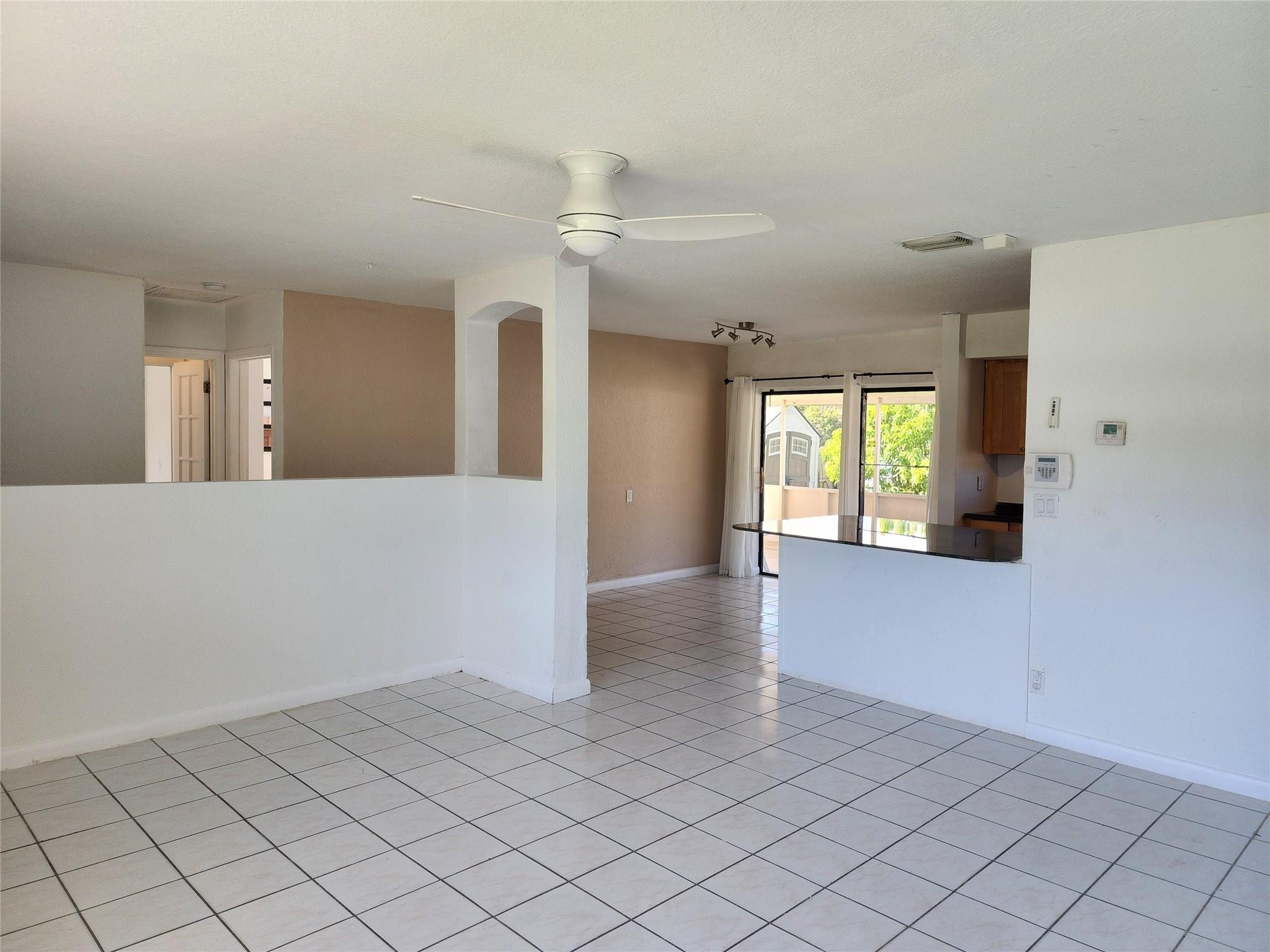 704 Southwest 4th Street Hallandale Beach, FL 33009 - Photo 27 of 33 a view of a hallway with wooden floor and chandelier