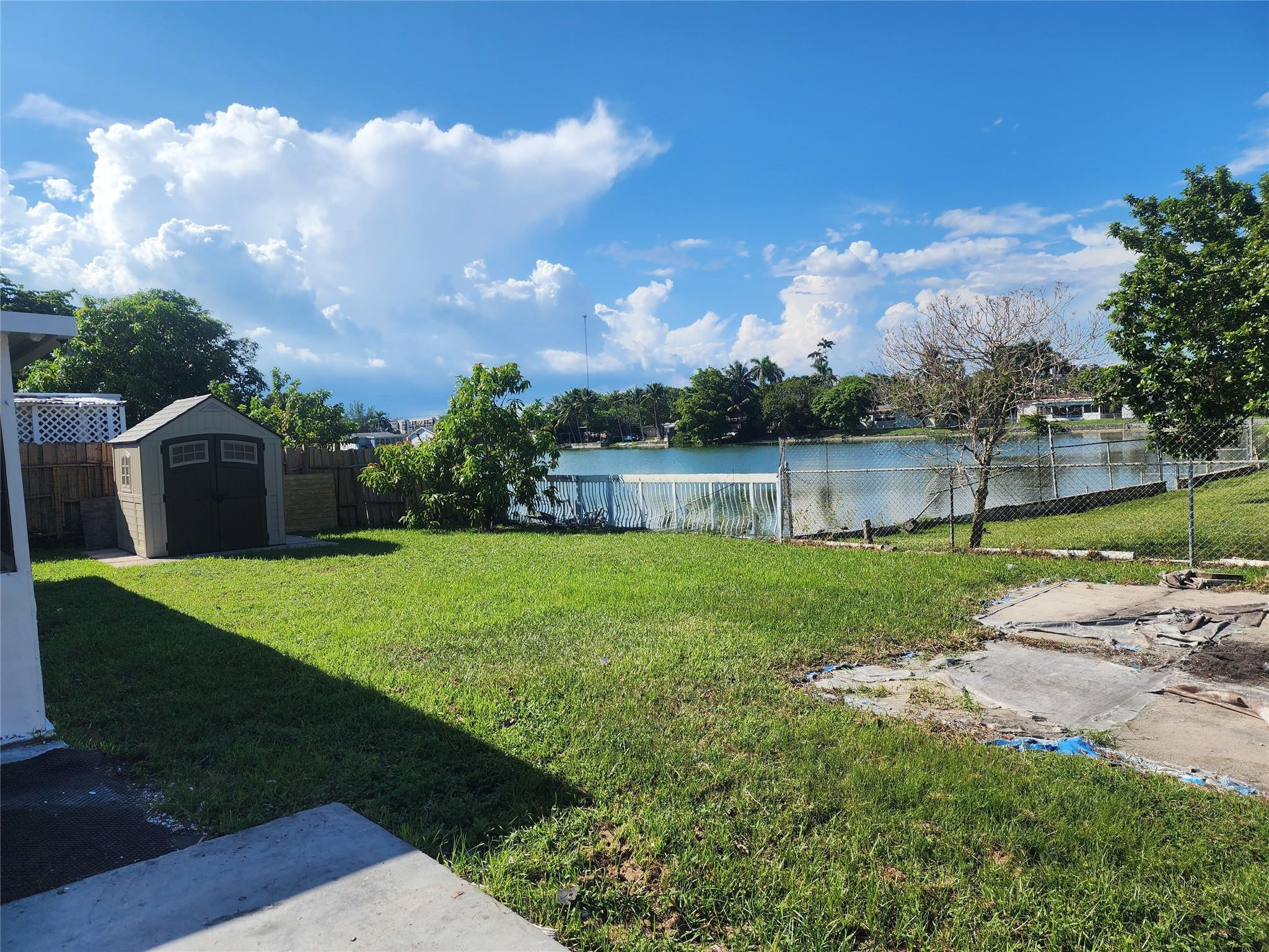 704 Southwest 4th Street Hallandale Beach, FL 33009 - Photo 4 of 33 a view of a house with backyard and a garden
