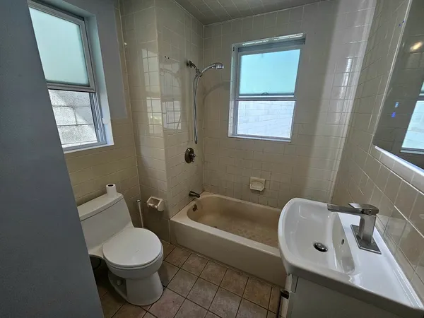 a white toilet sitting next to a bathroom sink