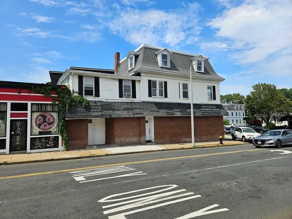 a front view of a house with a parking space