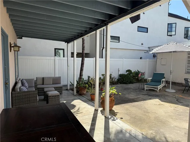 a building outdoor space with patio furniture and potted plants