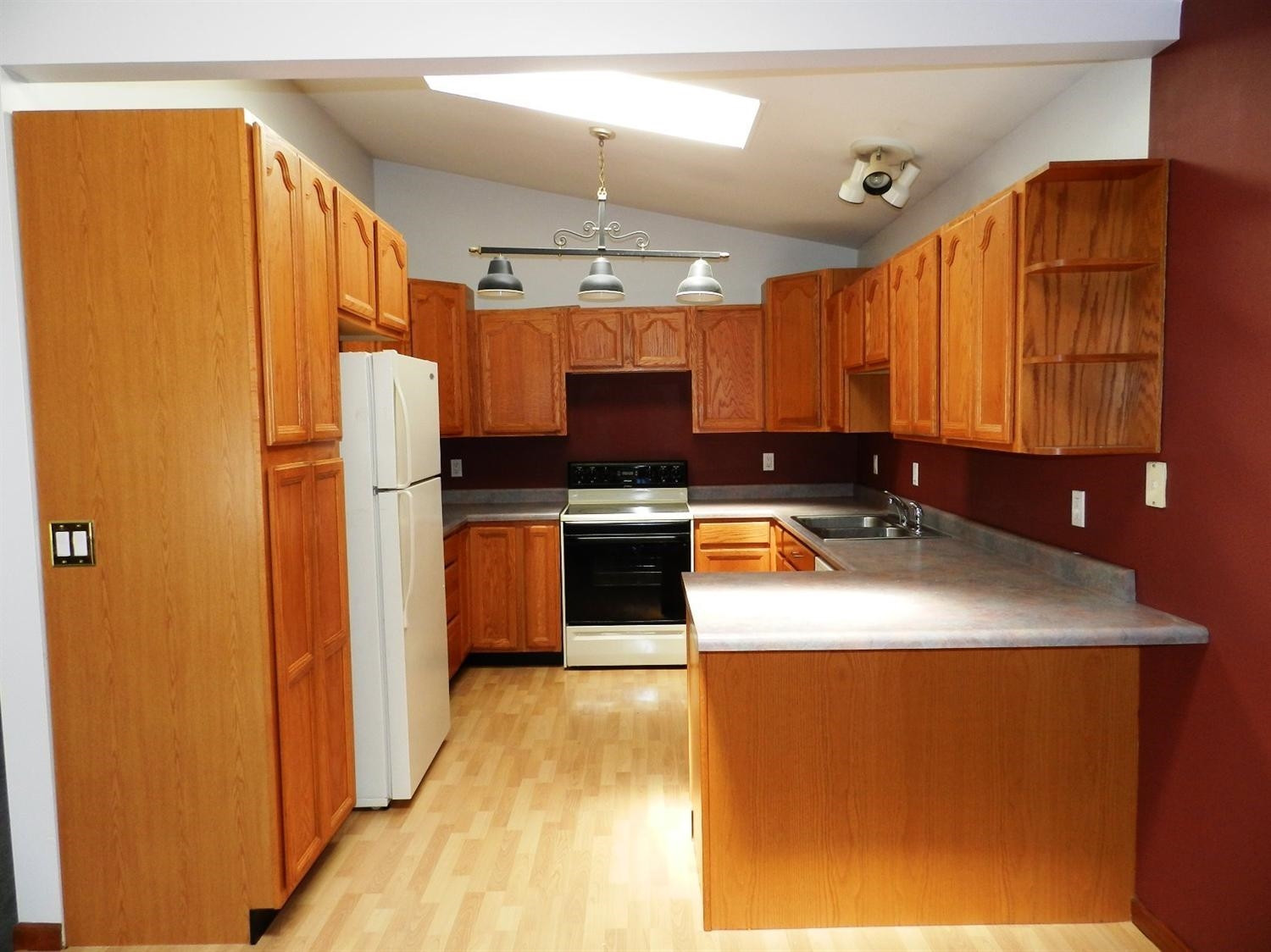 5611 Shepper Road Stockbridge, MI 49285 - Photo 8 of 10 KITCHEN WITH OAK CABINETS AND SKYLIGHT