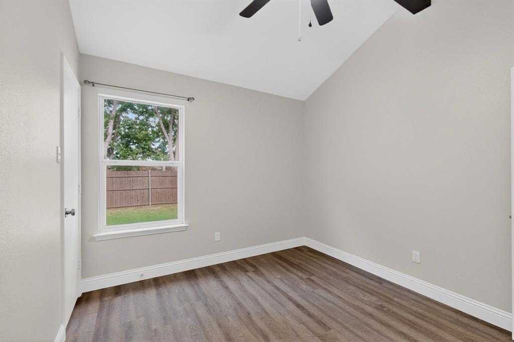 7729 Misty Ridge Drive North Fort Worth, TX 76137 - Photo 22 of 30 a view of an empty room with wooden floor and a window