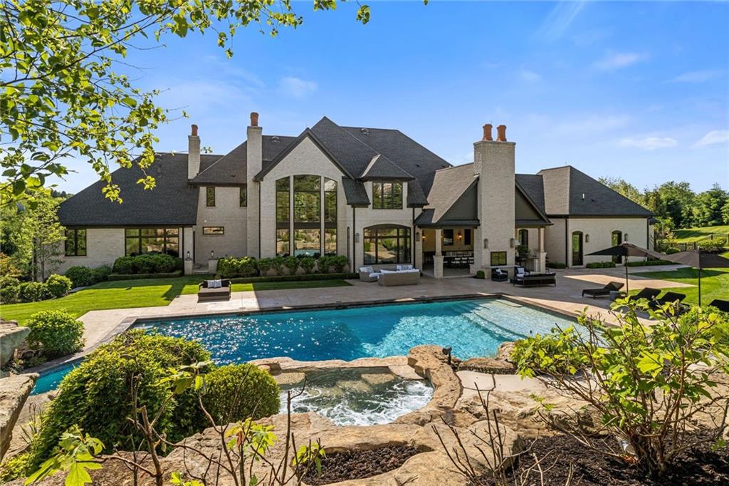 435 Myoma Road Mars, PA 16046 - Photo 39 of 50 Resort-style pool setting with cascading water features, multiple fire features, lush landscaping and the home's impressive rear elevation.