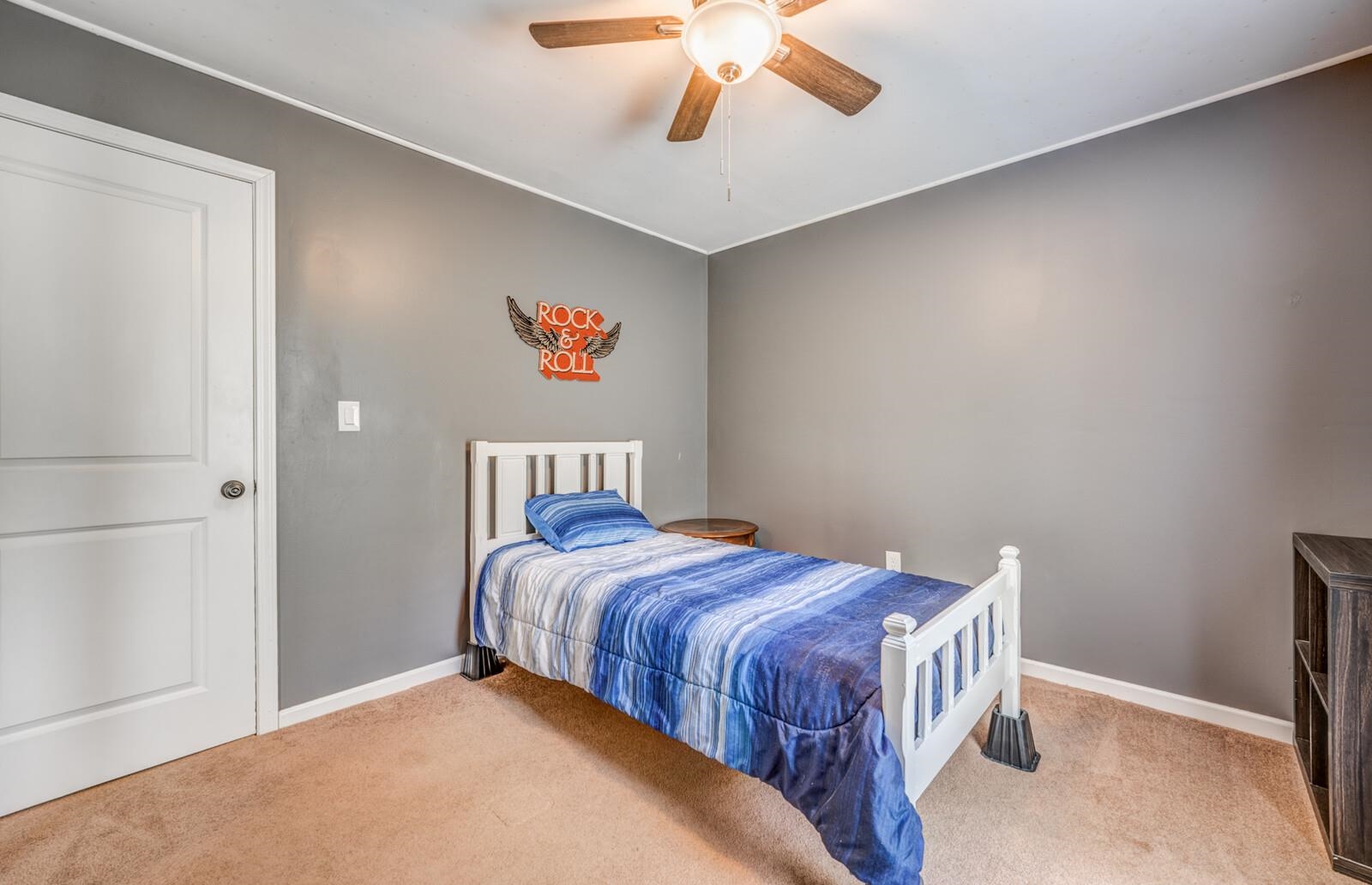 6125 Warren Road Oakland, TN 38060 - Photo 28 of 40 Neutral gray walls with white trim, brown carpet flooring, and a ceiling fan with integrated lighting