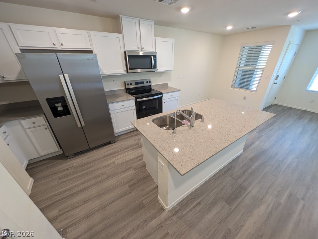4820 Orchid Rdg Avenue Las Vegas, NV 89141 - Photo 10 of 27 A well-appointed kitchen features a large island and ample cabinet space, seamlessly connecting to the living area.