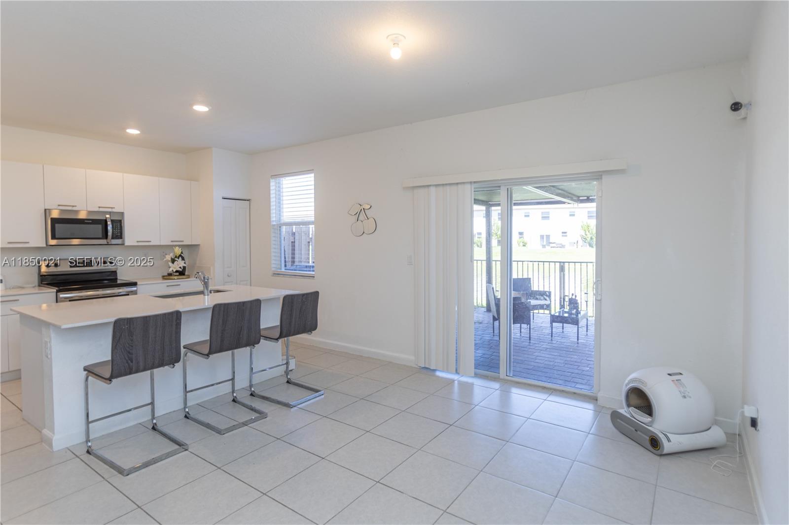 12561 Northwest 23rd Place Miami, FL 33167 - Photo 11 of 45 a view of kitchen with breakfast area