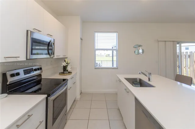 a kitchen that has a sink and a stove