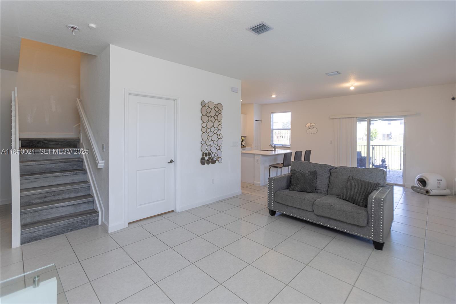 12561 Northwest 23rd Place Miami, FL 33167 - Photo 16 of 45 a living room with furniture and a wooden floor