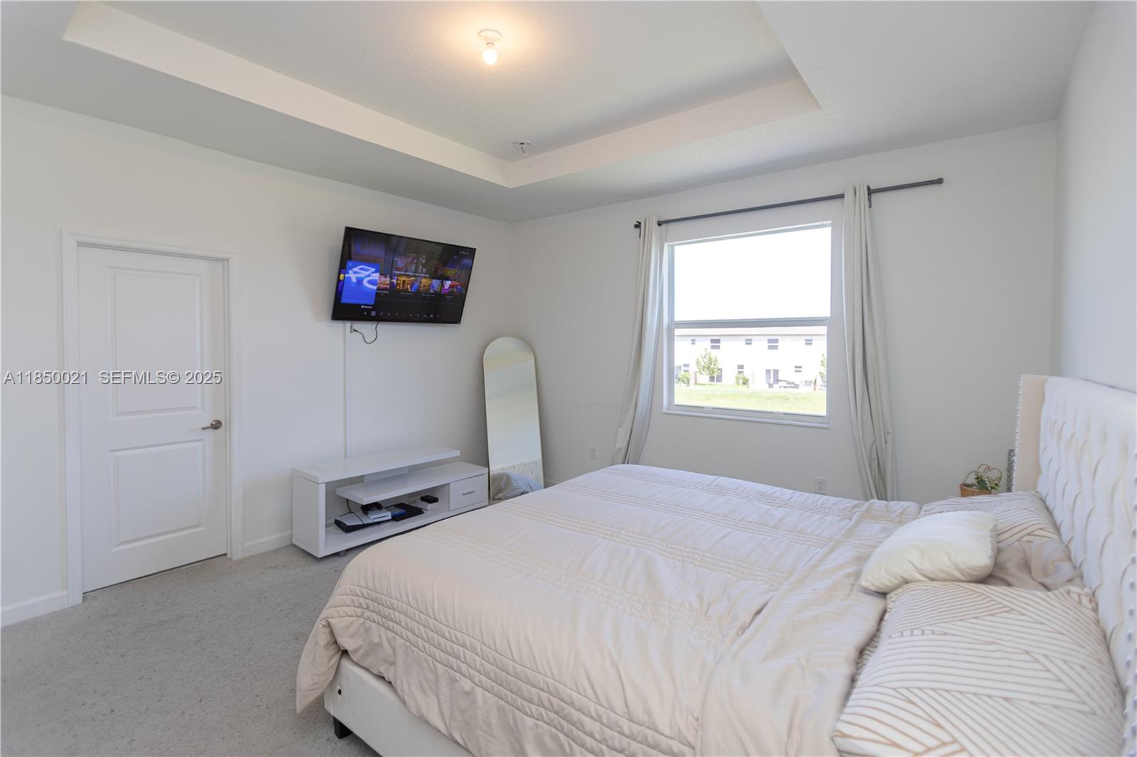 12561 Northwest 23rd Place Miami, FL 33167 - Photo 18 of 45 a bedroom with a bed and a tv