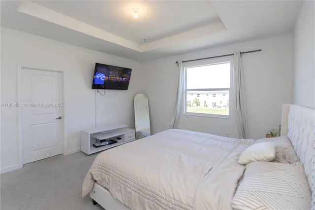 a bedroom with a bed and a tv