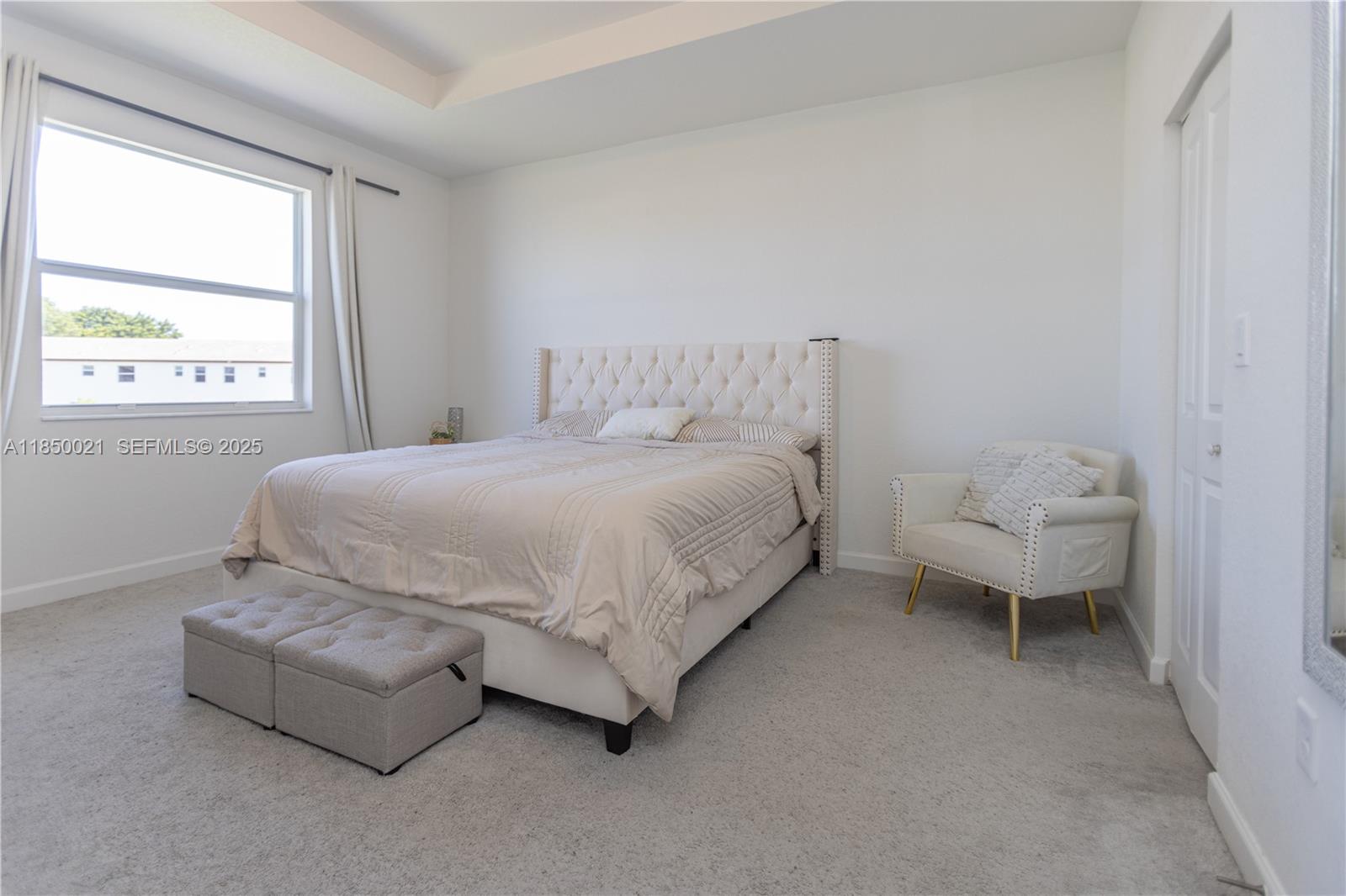 12561 Northwest 23rd Place Miami, FL 33167 - Photo 19 of 45 a bedroom with a bed and a couch