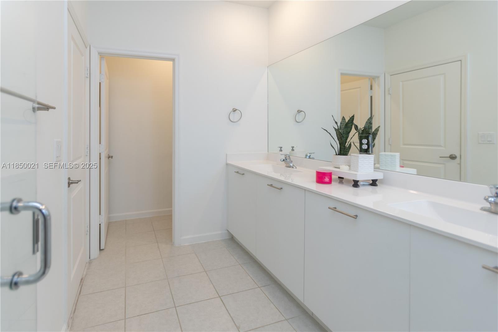 12561 Northwest 23rd Place Miami, FL 33167 - Photo 23 of 45 a bathroom with a sink vanity and mirror