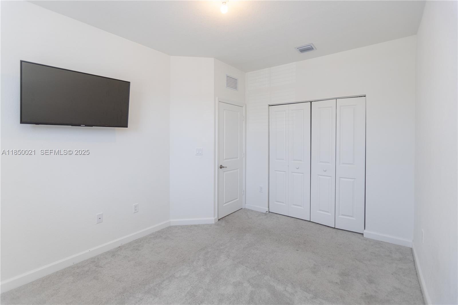 12561 Northwest 23rd Place Miami, FL 33167 - Photo 28 of 45 a view of an empty room with wooden floor and cabinet