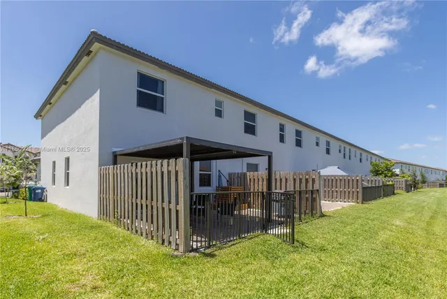 a front view of a house with backyard and porch