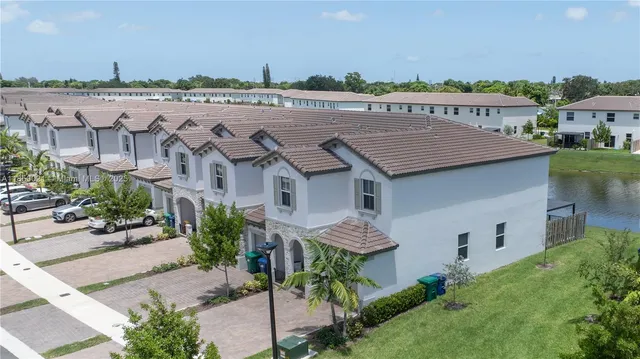 an aerial view of a house with a yard and plants