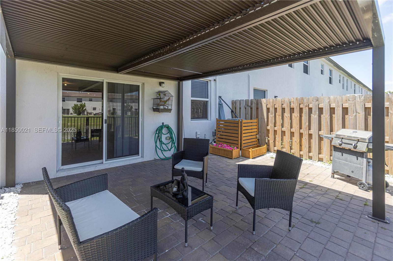 12561 Northwest 23rd Place Miami, FL 33167 - Photo 32 of 45 a outdoor living space with furniture and garden view