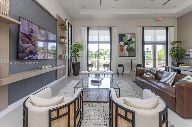 a living room with furniture and large windows
