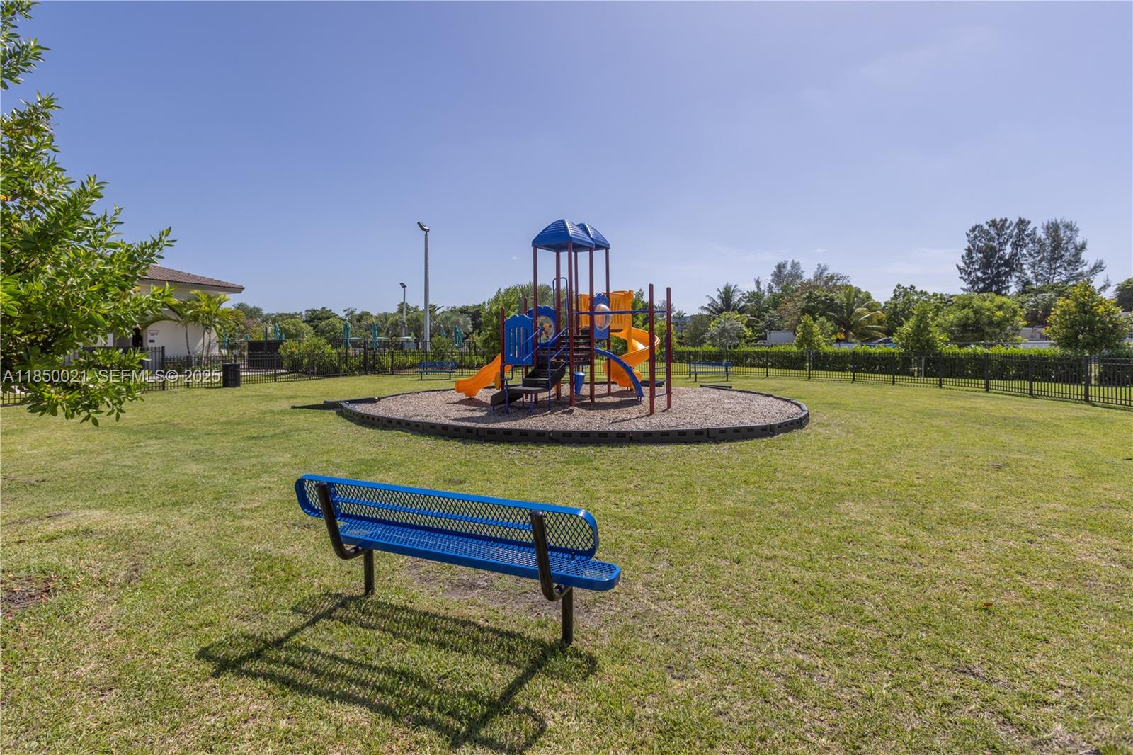 12561 Northwest 23rd Place Miami, FL 33167 - Photo 41 of 45 a bench is sitting in the middle of a lake