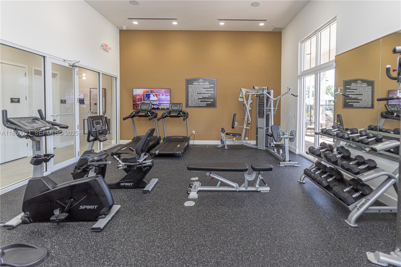 12561 Northwest 23rd Place Miami, FL 33167 - Photo 42 of 45 a room with gym equipment and a flat screen tv