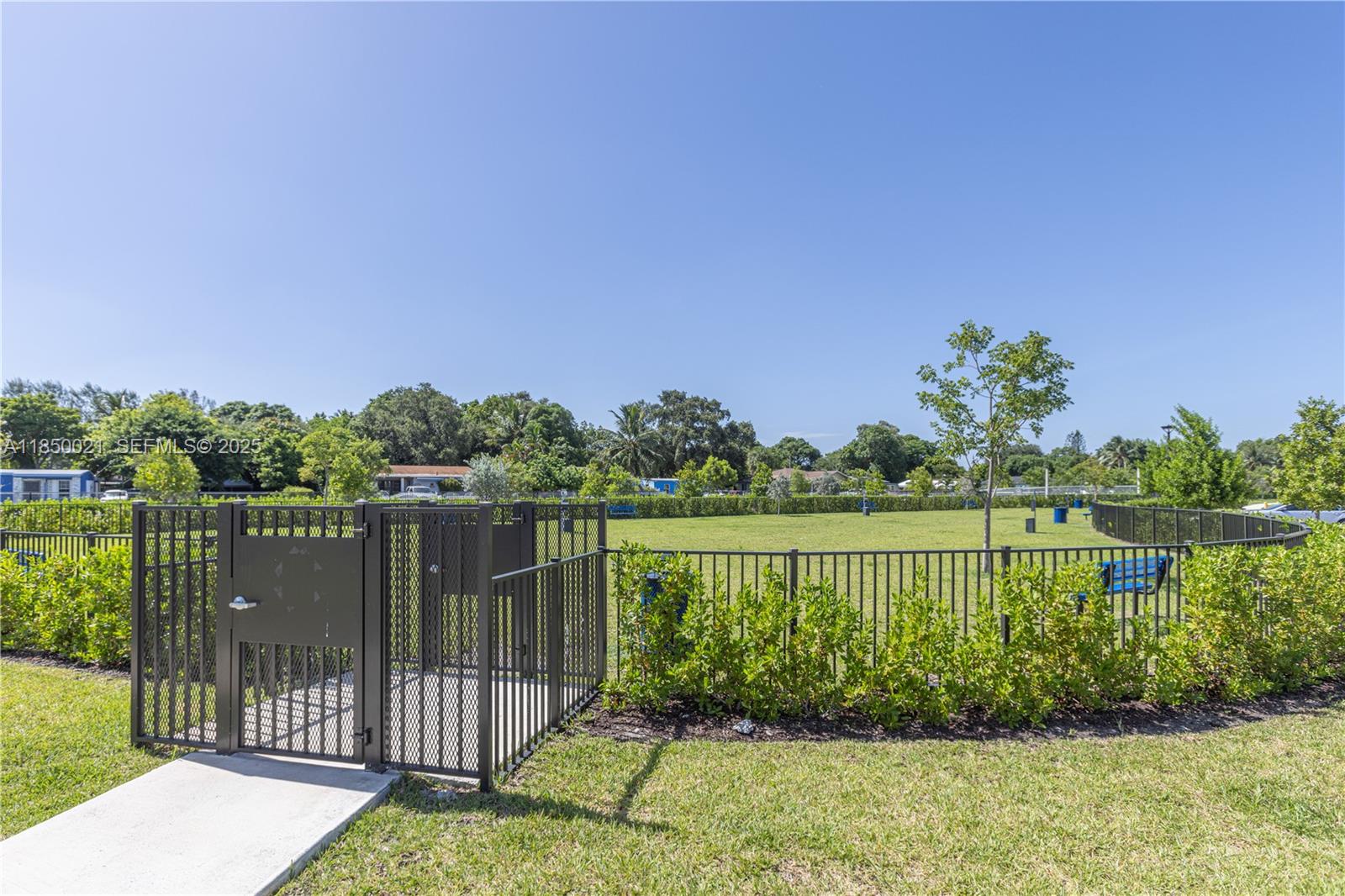 12561 Northwest 23rd Place Miami, FL 33167 - Photo 44 of 45 a view of a lake with a garden
