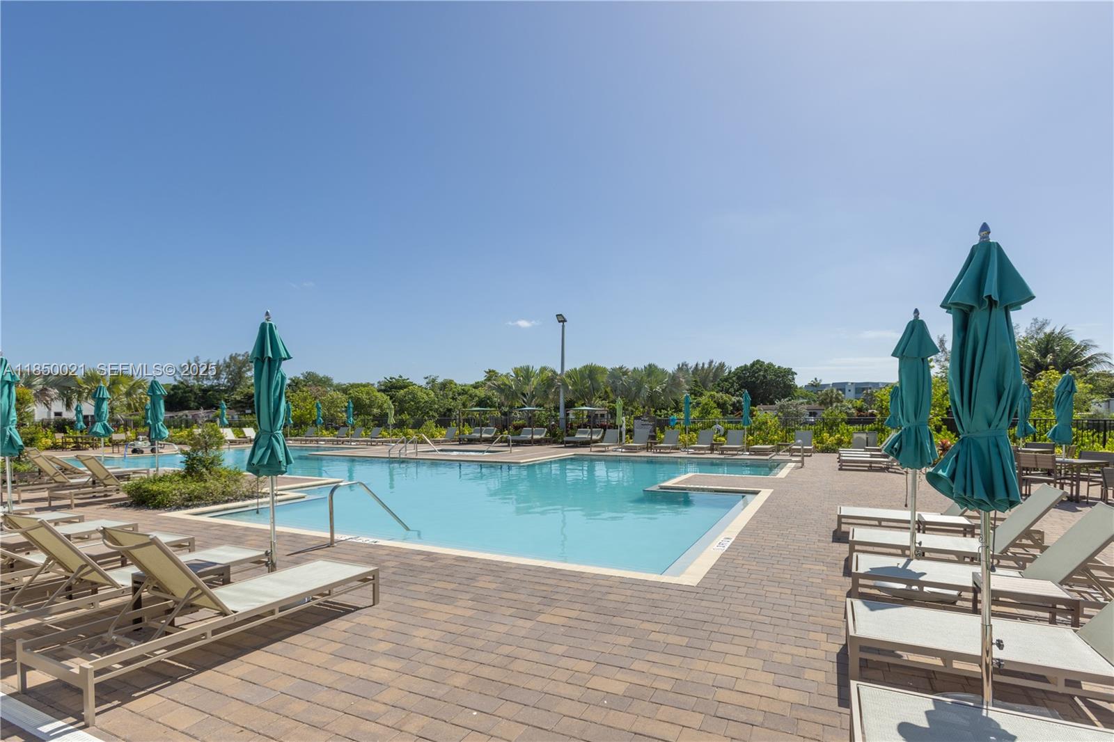 12561 Northwest 23rd Place Miami, FL 33167 - Photo 45 of 45 a view of a lake with a table and chairs
