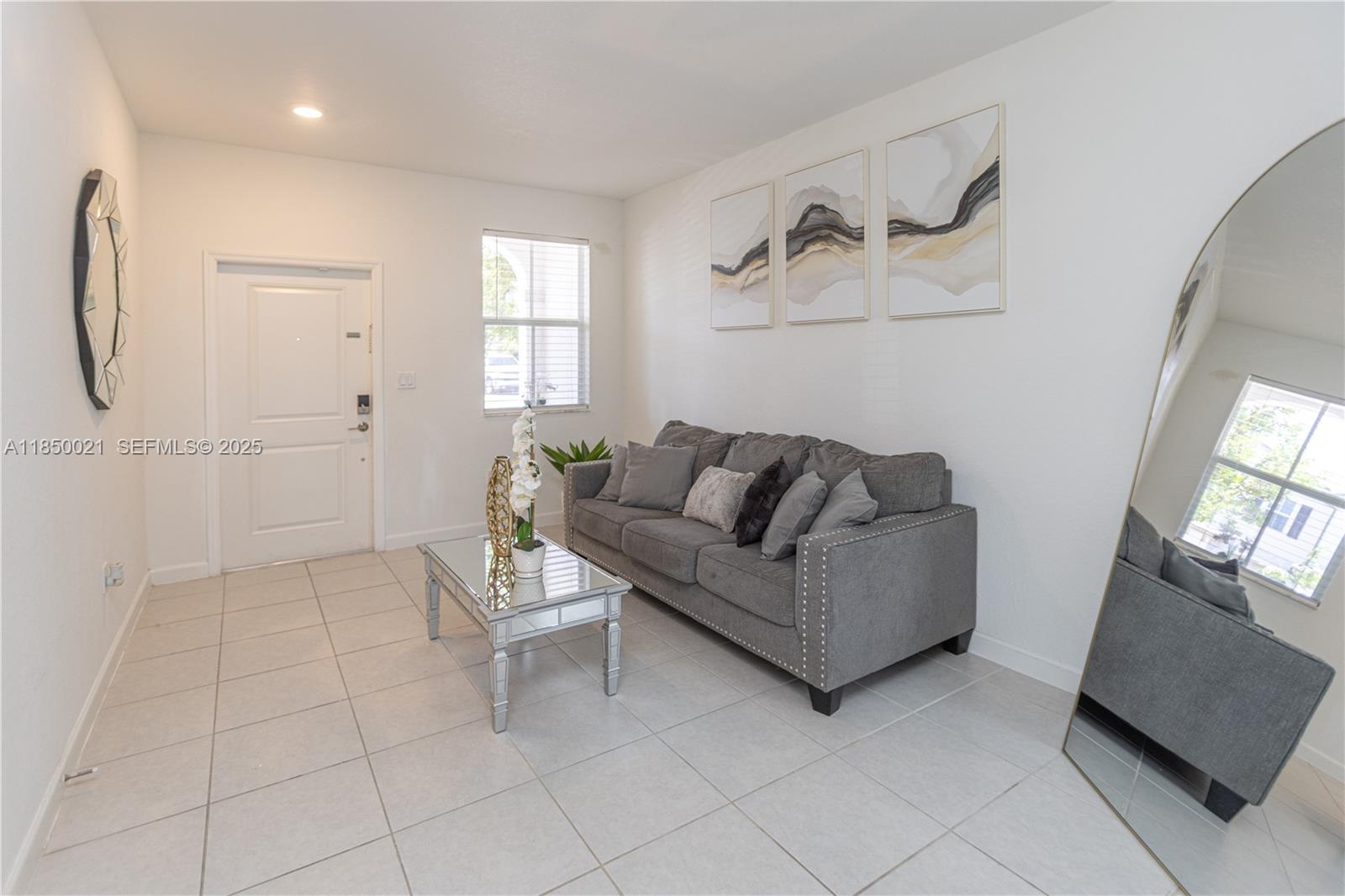 12561 Northwest 23rd Place Miami, FL 33167 - Photo 8 of 45 a living room with furniture and a flat screen tv