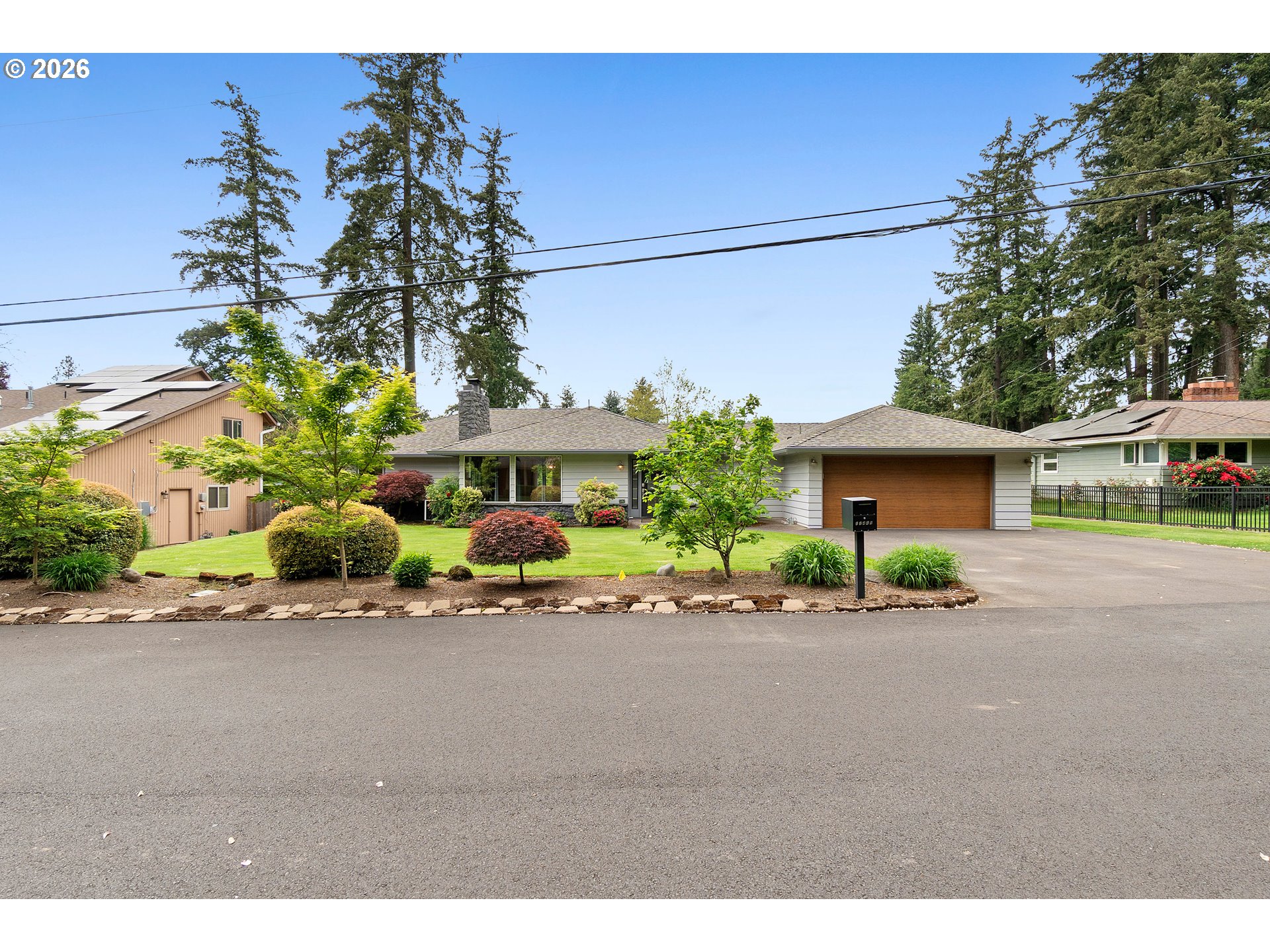 11465 Southwest 92nd Avenue Portland, OR 97223 - Photo 2 of 47 a front view of a house with a yard and a garage