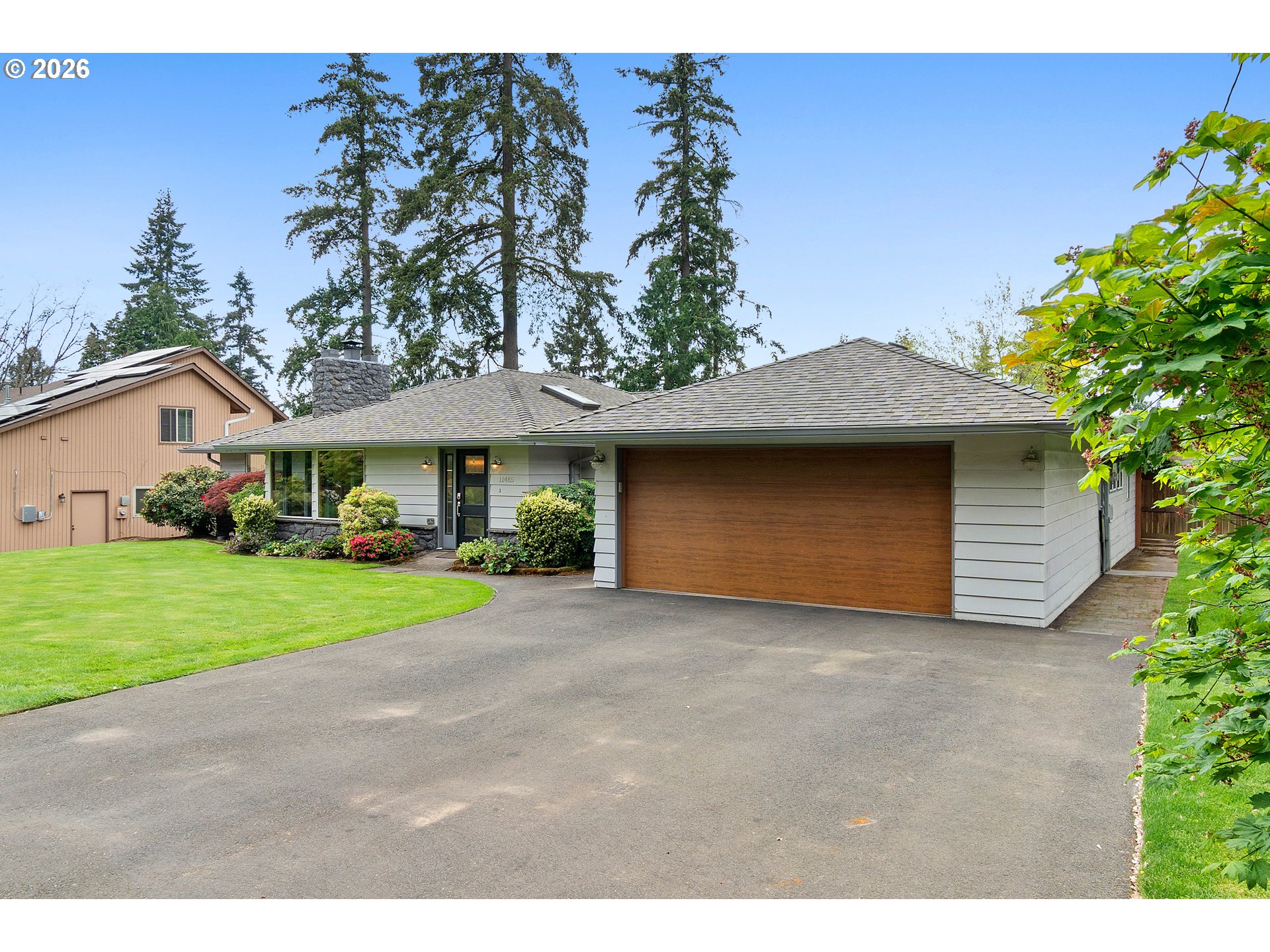 11465 Southwest 92nd Avenue Portland, OR 97223 - Photo 3 of 47 a view of a house with a yard and garage
