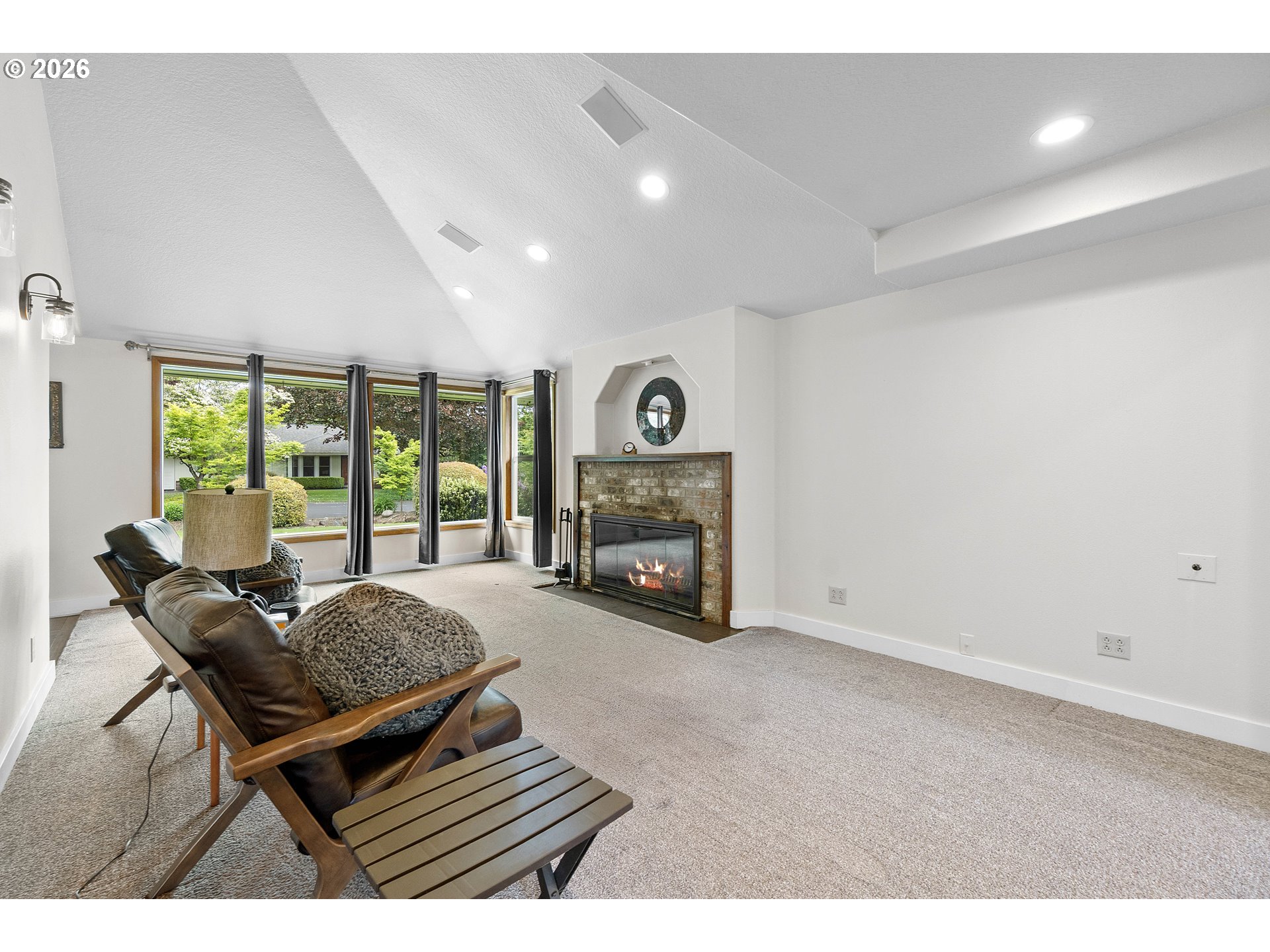11465 Southwest 92nd Avenue Portland, OR 97223 - Photo 5 of 47 a living room with furniture a fireplace and a floor to ceiling window