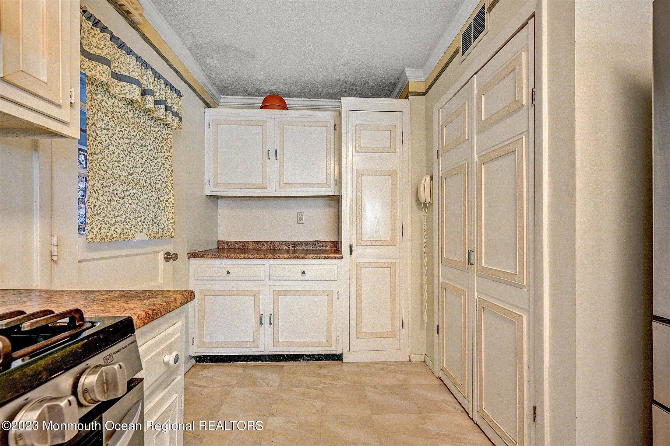40 Smith Street Howell, NJ 07731 - Photo 11 of 25 a kitchen with white cabinets and white appliances