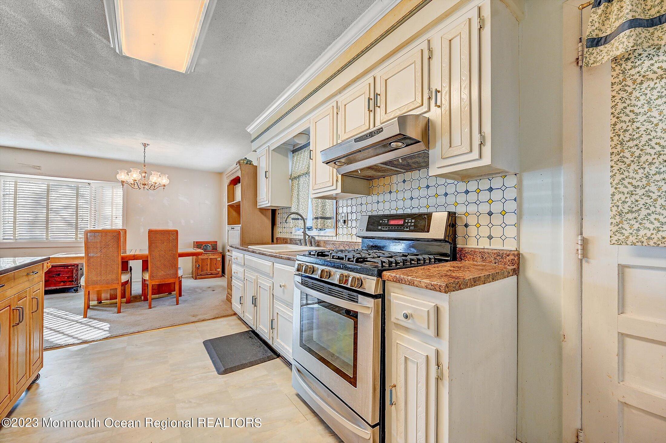 40 Smith Street Howell, NJ 07731 - Photo 12 of 25 a kitchen with stainless steel appliances granite countertop a stove and a refrigerator