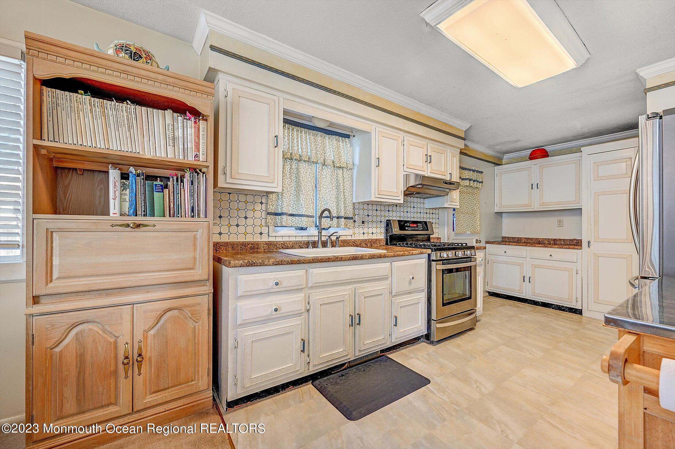 40 Smith Street Howell, NJ 07731 - Photo 10 of 25 a kitchen with granite countertop cabinets and white appliances