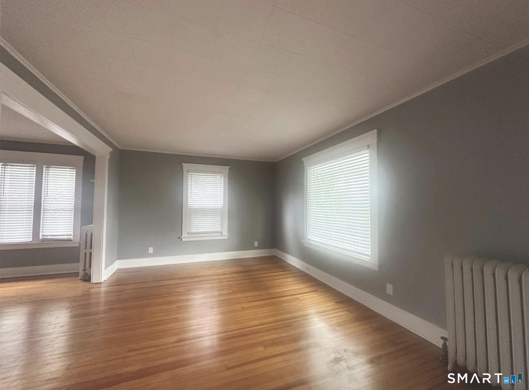 49 Dutton Street Wallingford, CT 06492 - Photo 9 of 10 an empty room with wooden floor and windows