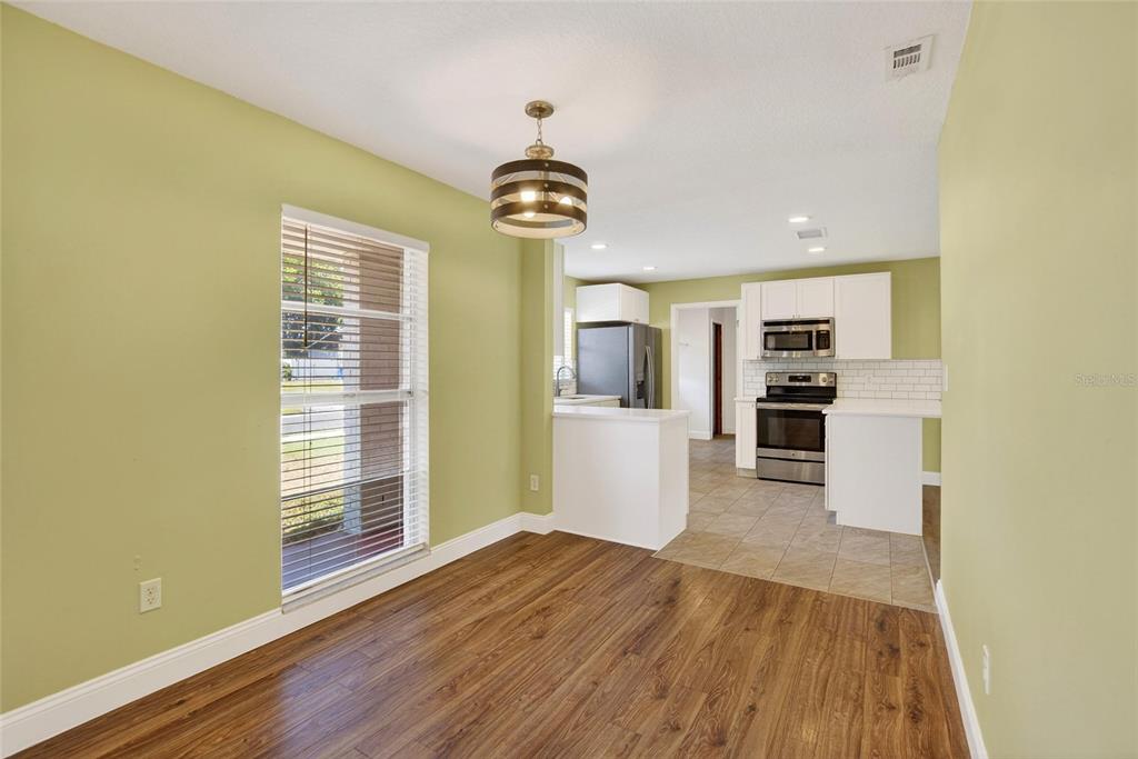 2340 Merrily Circle South Seffner, FL 33584 - Photo 9 of 52 a view of a kitchen with wooden floor and windows