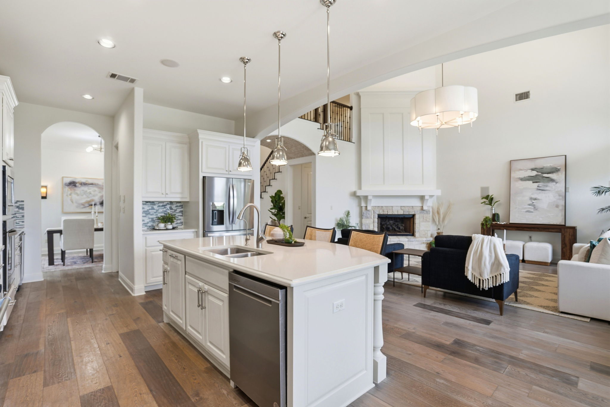 2420 Legend Trail Leander, TX 78641 - Photo 11 of 40 The ultimate social hub. From the massive prep island with its double sink to the cozy fireplace in the distance, this open layout ensures the chef is always part of the conversation.