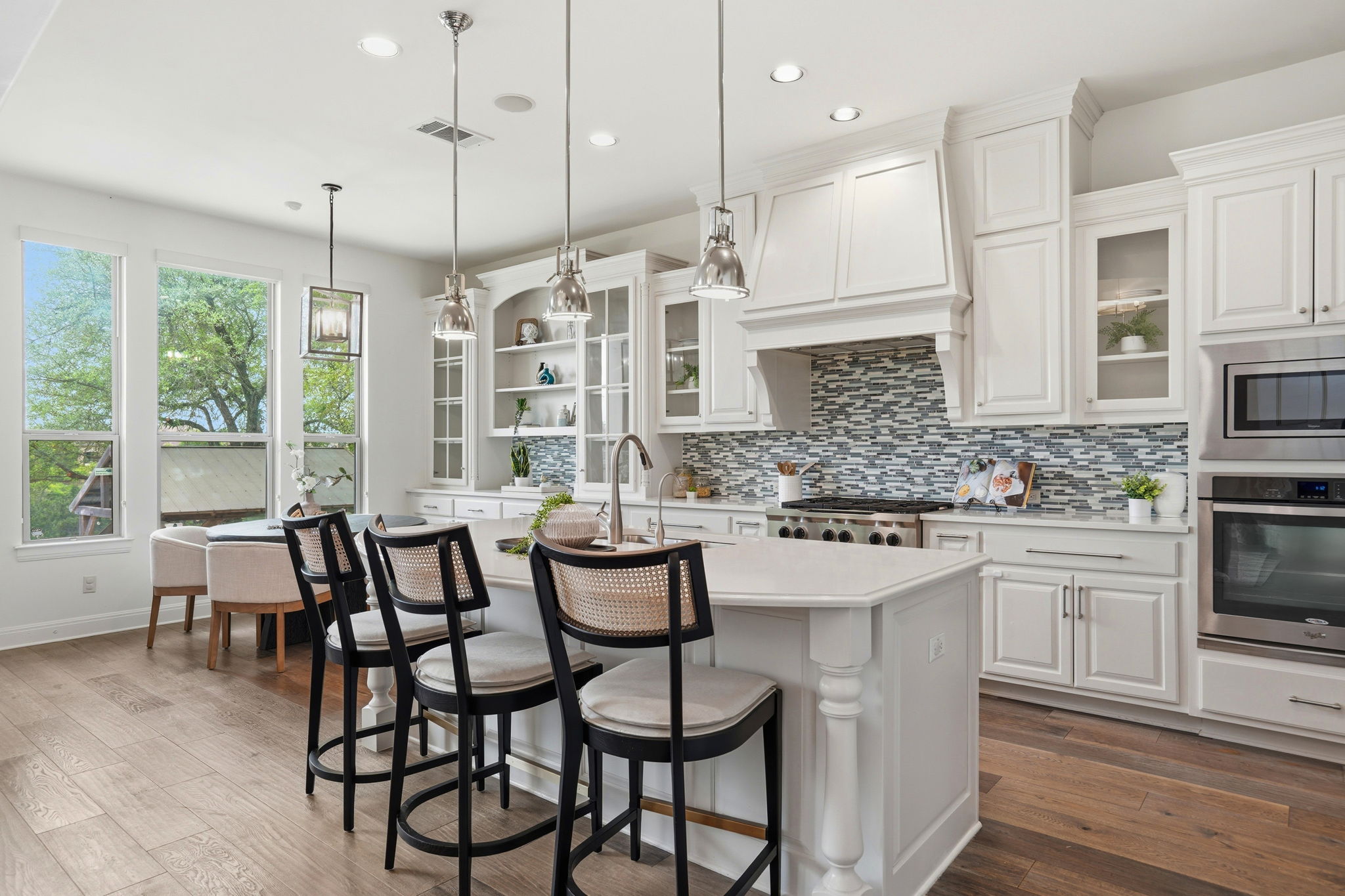 2420 Legend Trail Leander, TX 78641 - Photo 12 of 40 Morning coffee with a view. This dining area is surrounded by large windows, bringing the lush Texas greenery inside.